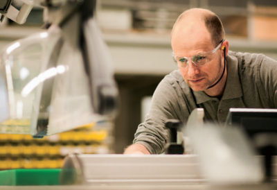 A photo of a man using an Altendorf panel saw