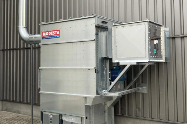 A close-up of a compact Modesta dust extraction unit